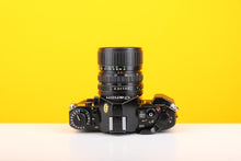 Load image into Gallery viewer, Canon A-1 35mm SLR Film Camera with Canon FD 35-70mm f3.5-4.5 Zoom Lens
