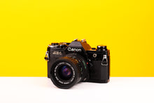 Load image into Gallery viewer, Canon AE-1 35mm SLR Film Camera with Canon Zoom FD 35-70mm f3.5-4.5 Lens
