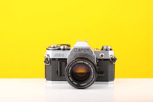 Load image into Gallery viewer, Canon AE-1 35mm SLR Film Camera with Canon FD 50mm f1.4 Lens
