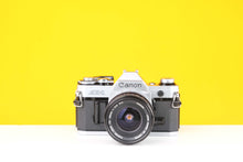 Load image into Gallery viewer, Canon AE-1 35mm SLR Film Camera with Canon S.C. 28mm f3.5 Lens
