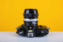 Load image into Gallery viewer, Nikon EM 35mm Film Camera with Micro-Nikkor Auto 55mm f3.5 Lens
