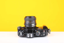 Load image into Gallery viewer, Nikon F-301 35mm SLR Film Camera with Bell&amp;Howell 28mm f2.8 Lens
