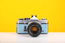 Load image into Gallery viewer, Olympus OM2n 35mm Film Camera in New Light Blue Leather Skin with Zuiko Olympus OM-System Auto-S 50mm f1.8 Lens
