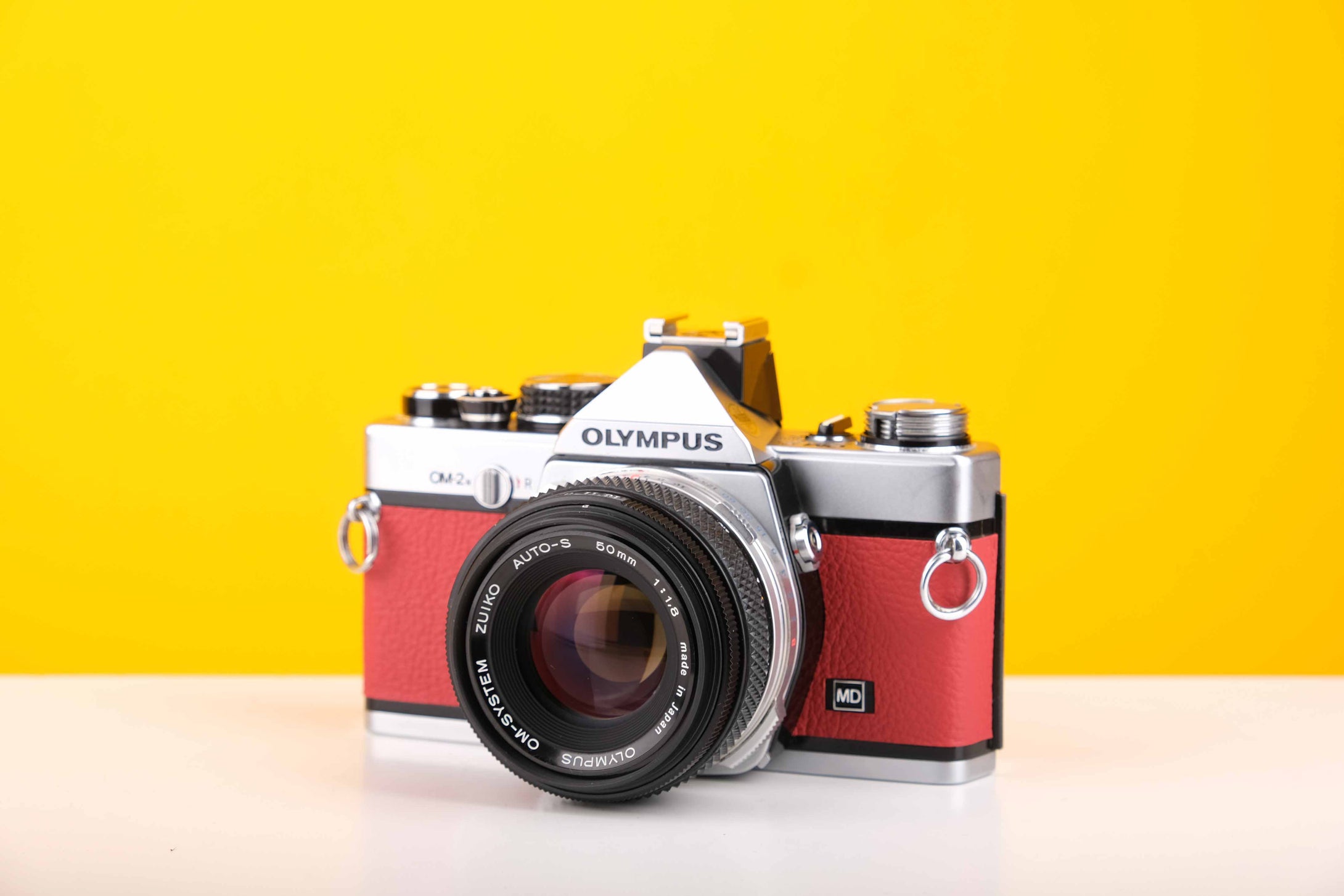 Olympus OM-2n MD 35mm SLR Film Camera with Zuiko Olympus OM-System Auto-S 50mm f1.8 Lens in Red