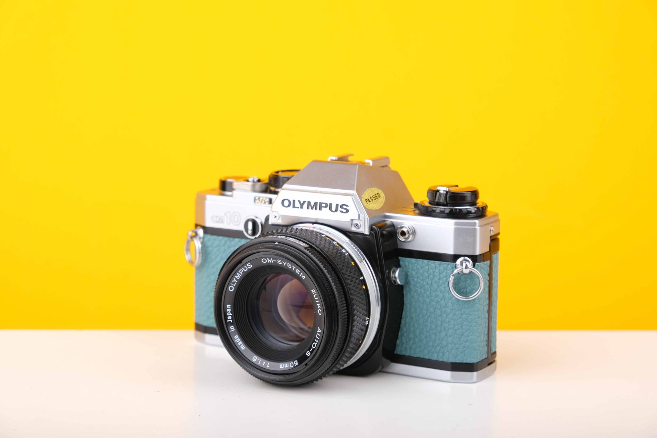 Olympus OM10 35mm Film Camera with Olympus Zukio Auto-S 50mm f1.8 Lens in Turquoise