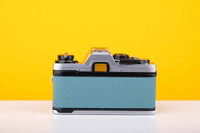 Load image into Gallery viewer, Olympus OM10 35mm Film Camera with Olympus Zukio Auto-S 50mm f1.8 Lens in Turquoise
