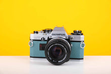 Load image into Gallery viewer, Olympus OM10 35mm Film Camera with Olympus Zukio Auto-S 50mm f1.8 Lens in Turquoise
