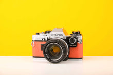 Load image into Gallery viewer, Olympus OM10 35mm SLR Film Camera with Manual Adapter and Olympus Zuiko Auto-S 50mm f1.8 Lens in Orange
