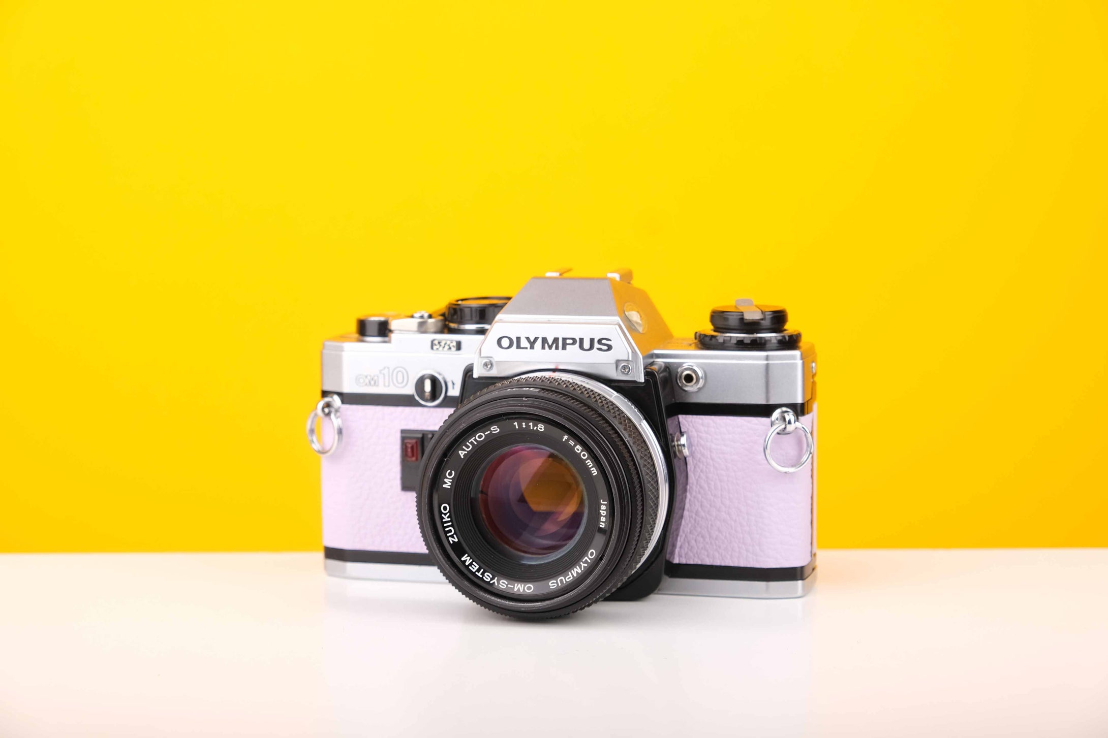 Olympus OM10 35mm SLR Film Camera with Manual Adapter and Olympus Zuiko MC Auto-S 50mm f1.8 Lens in Lilac