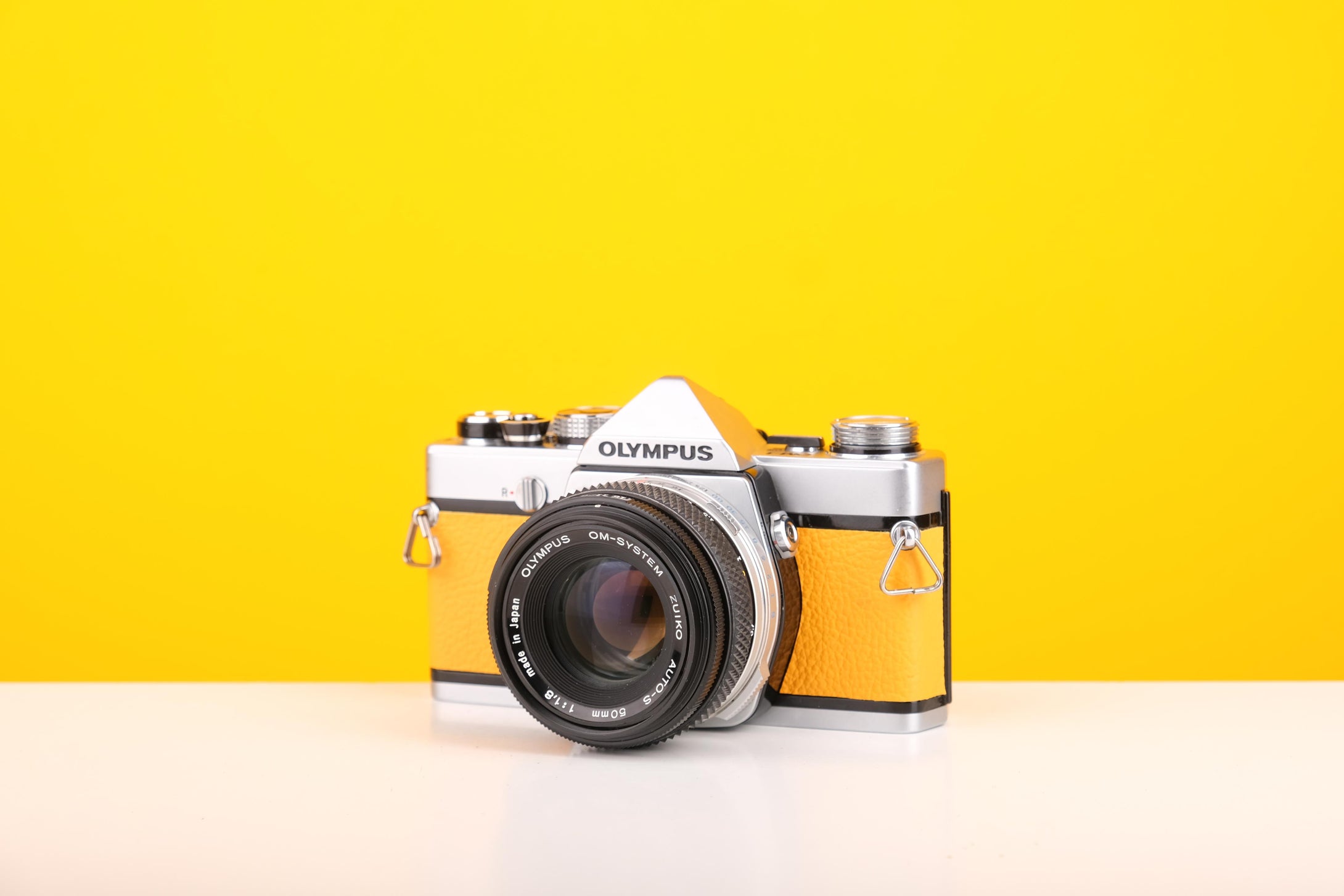 Olympus OM-1 35mm SLR Film Camera with Olympus OM-System Zuiko Auto-S 50mm f1.8 Lens in Yellow