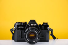 Load image into Gallery viewer, Canon AE-1 Black Mint 35mm SLR Film Camera With 50mm F/1.8 Prime Lens
