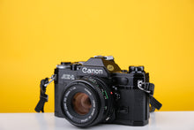 Load image into Gallery viewer, Canon AE-1 Black 35mm SLR Film Camera With 50mm F/1.8 Prime Lens
